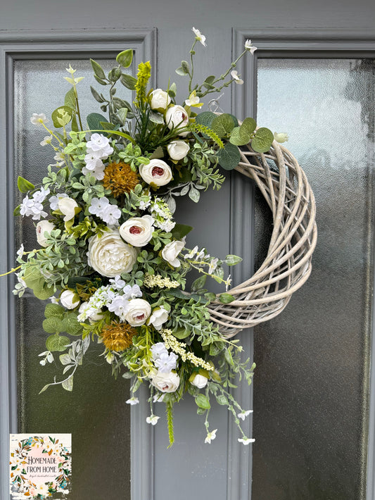 Ivory ranunculus and forget me not wreath