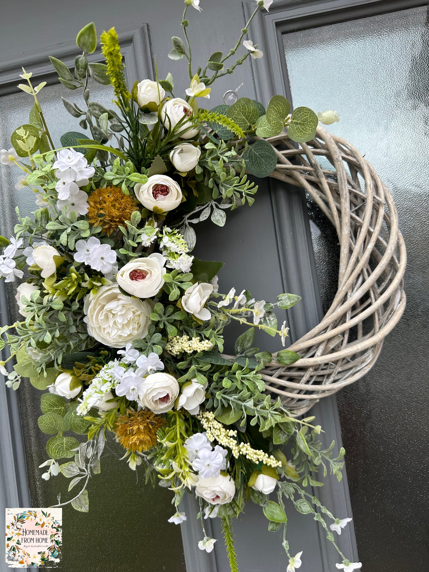 Ivory ranunculus and forget me not wreath