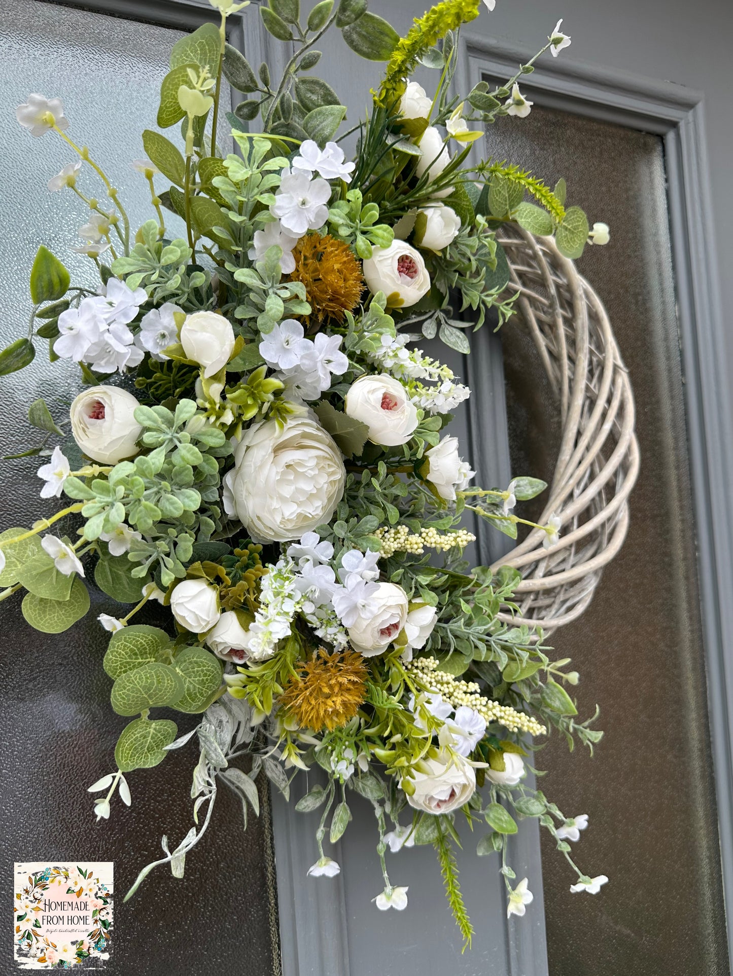 Ivory ranunculus and forget me not wreath