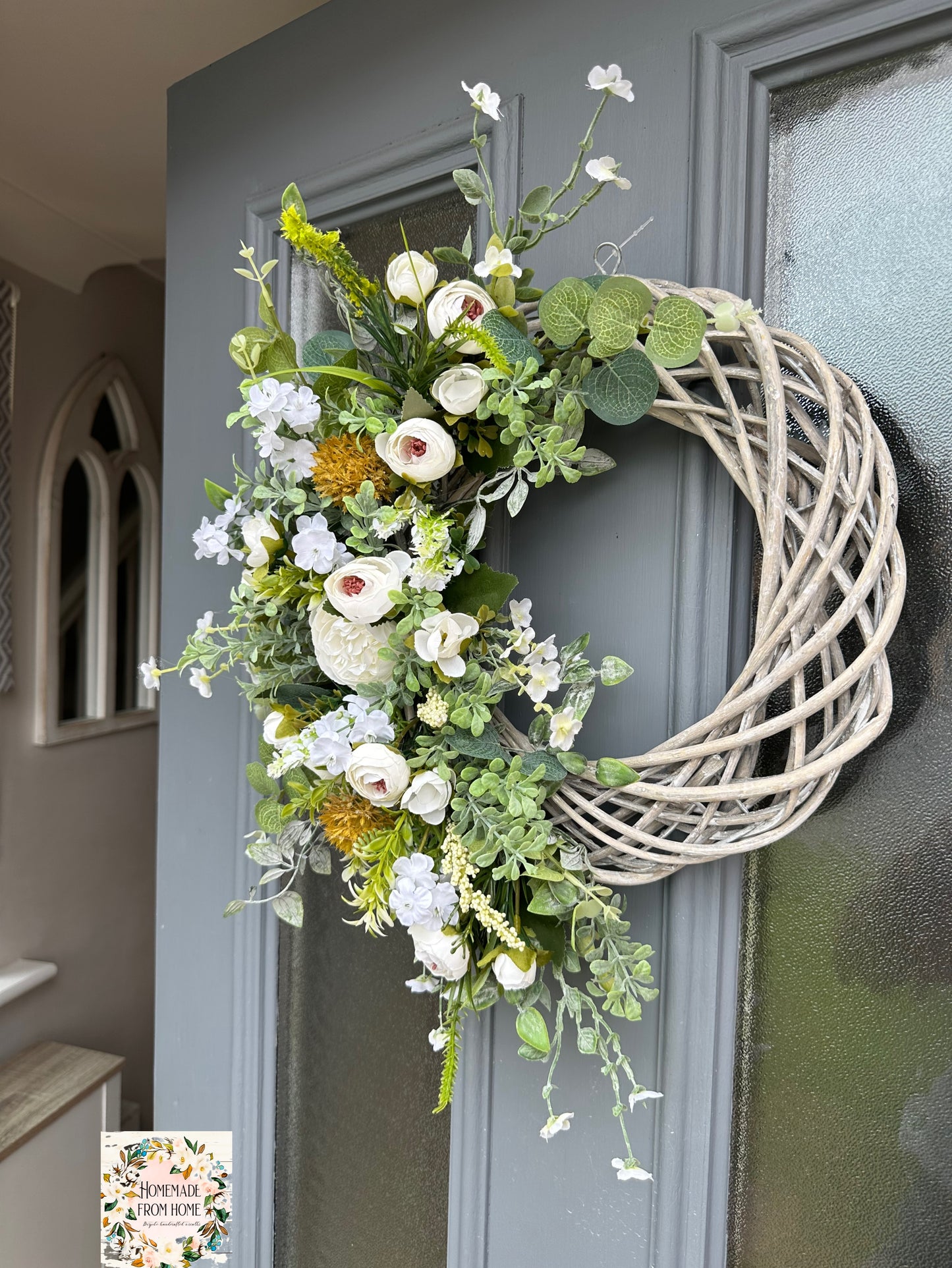 Ivory ranunculus and forget me not wreath